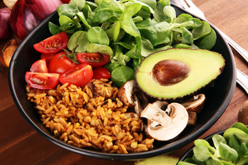 Healthy vegan salad bowl with quinoa, tomatoes, avocado and mixed greens, lettuce. Food and health bowl