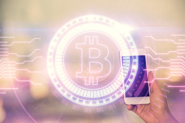Double exposure of blockchain business sketch hologram and woman holding and using a mobile device.