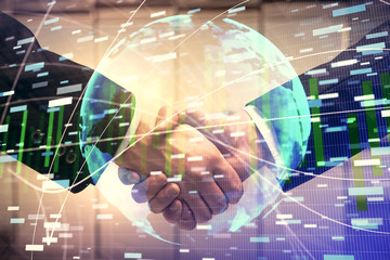 Double exposure of business theme hologram and handshake of two men. Success concept.