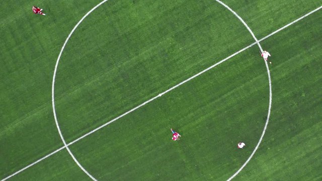 Aerial Top Down View of Soccer Field. Beginning of game. Two teams playing ball in football outdoors. Head over shot.