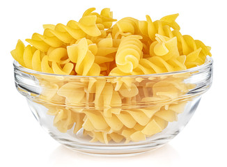 Dried italian pasta spiral Fusilli in a small transparent glass round bowl isolated on white...