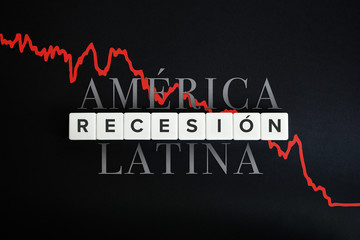 Fototapeta premium America Latina la recesion economica (Latin America economic recession) caused by coronavirus crisis and covid-19 outbreak. Spanish text and block letters on black background.