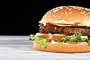 Premium craft of burger with juicy beef patty garnished by fresh lettuce, white onions and cheese. Perfect for satisfying your food delivery cravings.