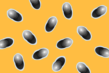 Modern minimalistic easter pattern. Black and white eggs on yellow background.