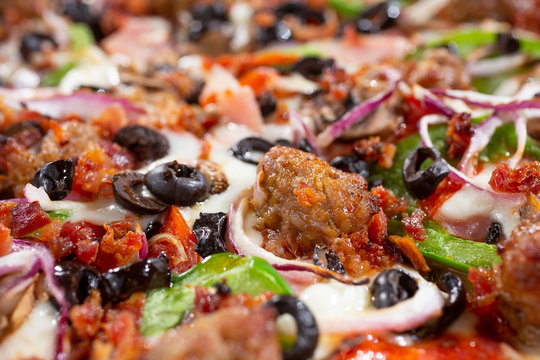 A closeup view of a supreme pizza, as a background image.
