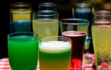 Glasses with a cocktail. Multicolored drinks. Drunk party.