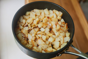 Cooked golden potatoes in a frying pan