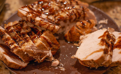 Close up of a plate of home-made pork loin with sauce with selective focus