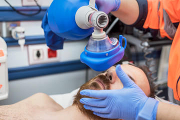 Covid-19 respiratory insufficiency. Urgency doctor using mask Ambu bag on a patient with pneumonia...