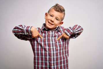 Young little caucasian kid with blue eyes wearing elegant shirt standing over isolated background looking confident with smile on face, pointing oneself with fingers proud and happy.