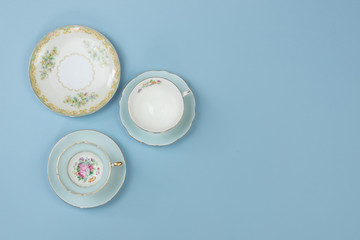 Pretty vintage china teacups on blue background