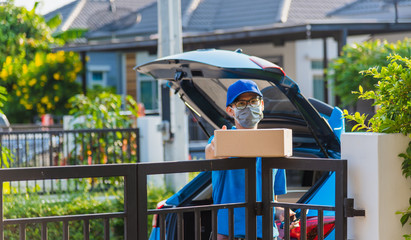 delivery man with box he protective face mask, service customer in front of the house