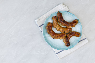 Fried Sausages in the frying pan with copy space on the grey marble table
