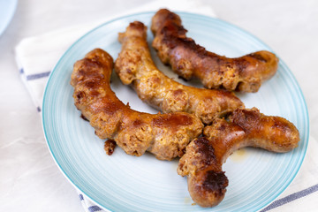 Fried Sausages in the frying pan with copy space on the grey marble table