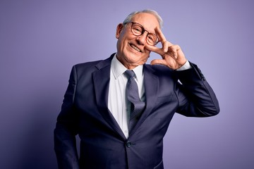 Grey haired senior business man wearing glasses and elegant suit and tie over purple background Doing peace symbol with fingers over face, smiling cheerful showing victory