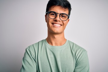 Young handsome man wearing casual t-shirt and glasses over isolated white background happy face...