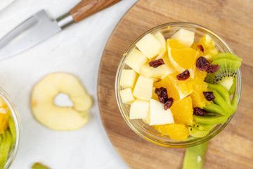 Fruit salad with kiwi orange and apple in the bowl