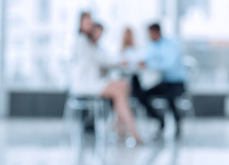 abstract blurred group of business people sitting at a table