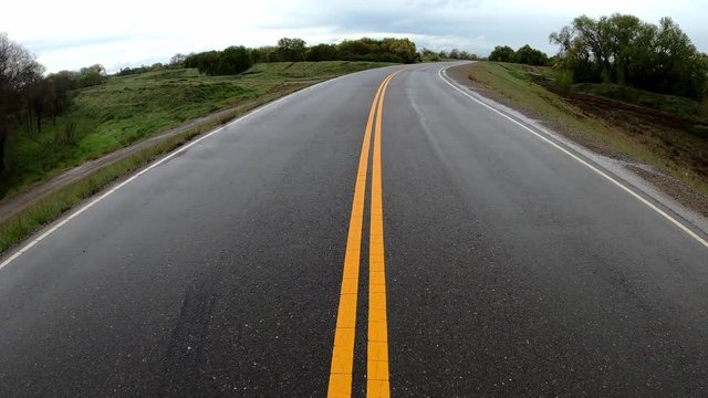 Time lapse fallowing yellow lines on a levee road