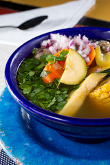 A view of a vegetable soup, in a restaurant or kitchen setting.