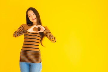 Portrait beautiful young asian adult woman smile with many action on yellow background