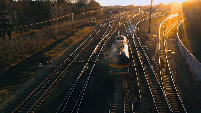 train at the fork of the tracks at sunset aerial view.
