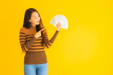 Portrait beautiful young asian woman happy smile and rich with a lot of cash in her hand