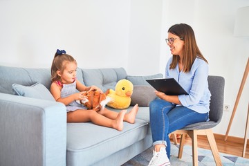 Young therapist woman speaking and treating child, counselor and behaviour correction at pedagogue...