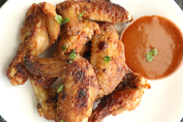 Delicious chicken wings, baked or fried chicken wings served with hot spicy  barbeque sauce