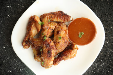 Delicious chicken wings, baked or fried chicken wings served with hot spicy  barbeque sauce