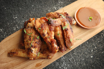 Delicious chicken wings, baked or fried chicken wings served with hot spicy  barbeque sauce