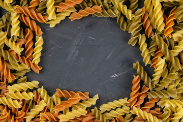 Fusili pasta. Closeup of raw fusilli macaroni in spiral shape with empty middle for messages. On a...