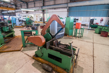 industrial 
hacksaw in a workshop for geothermal power plant construction and maintenance jobs