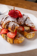 A view of a fruit croissant sandwich with chocolate hazelnut spread