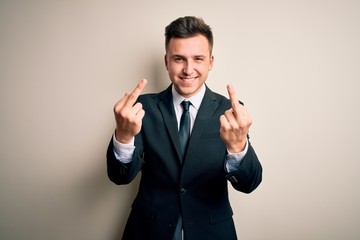 Young handsome business man wearing elegant suit and tie over isolated background Showing middle finger doing fuck you bad expression, provocation and rude attitude. Screaming excited