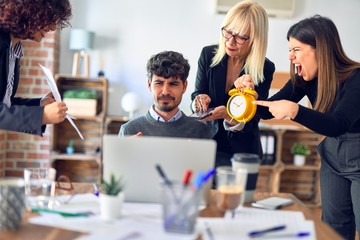 Group of business workers working together. Partners stressing one of them at the office