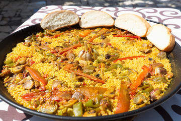 Vegetable paella made on fire with organic ingredients.