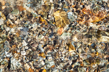 Beautiful stones on the bottom of a clean river, natural background