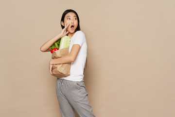 woman holding a bag full of food