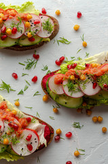 open sandwich with beetroot hummus with vegetables and tomato sauce.