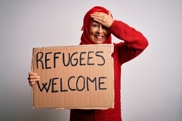 Woman wearing muslim hijab asking for immigration holding welcome refugees message stressed with...