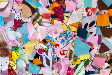 Background colorful pieces of fabric to shreds.