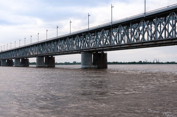 Fototapeta na wymiar Russia, Khabarovsk, August 2019: Road bridge on the Amur river in the city of Khabarovsk in the summer