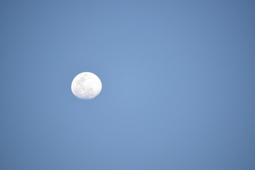 Full moon in the blue sky.