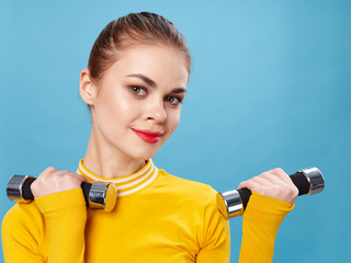 young woman with dumbbells