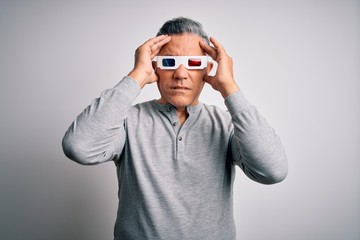 Middle age handsome grey-haired man using 3d glasses over isolated white background suffering from headache desperate and stressed because pain and migraine. Hands on head.