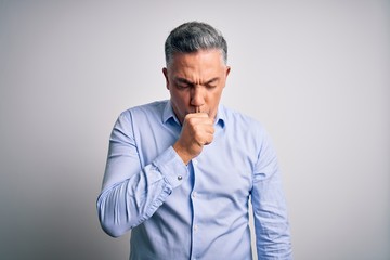 Middle age handsome grey-haired business man wearing elegant shirt over white background feeling unwell and coughing as symptom for cold or bronchitis. Health care concept.