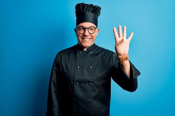 Middle age handsome grey-haired chef man wearing cooker uniform and hat showing and pointing up...