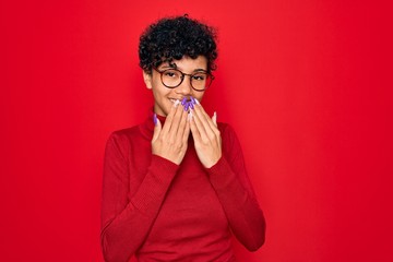 Young beautiful african american afro woman wearing turtleneck sweater and glasses laughing and...