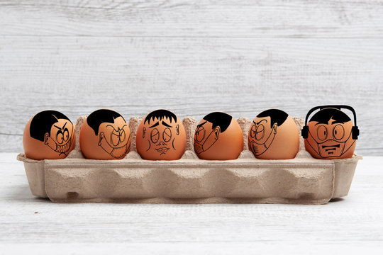 Self isolation and social distancing during Easter concept depicted with cartoon faces drawn on easter eggs with copy space